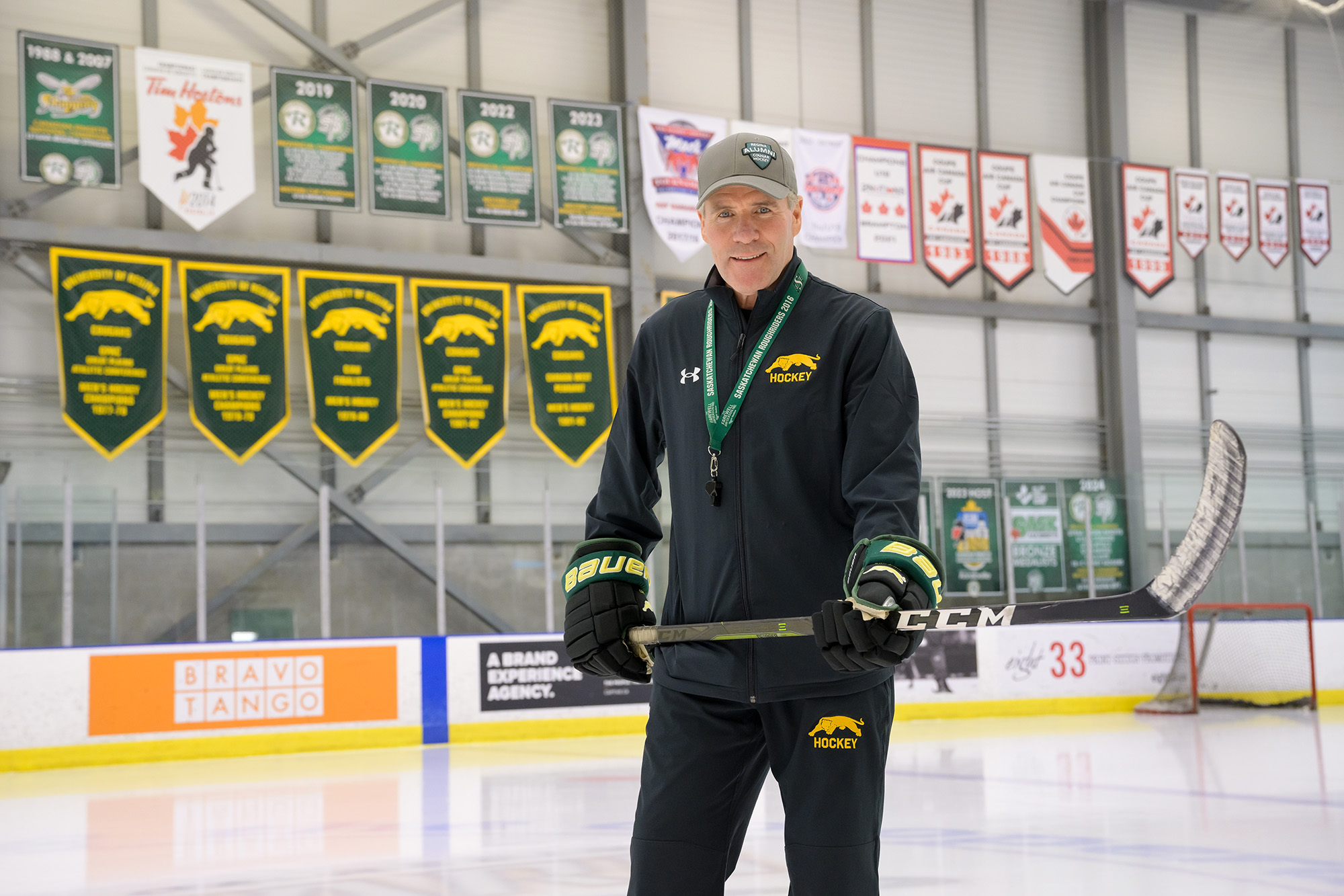 Smiling individual at hockey rink.